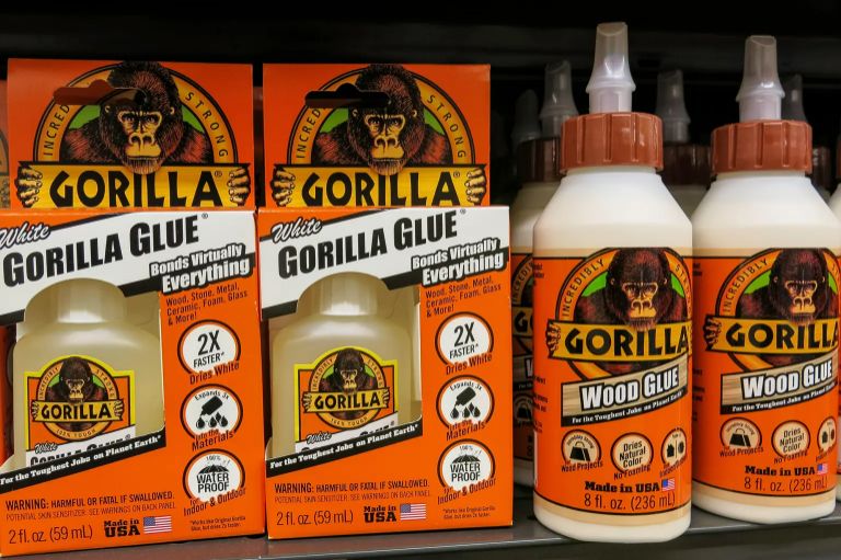 Big orange bottles of Gorilla Glue on a shelf